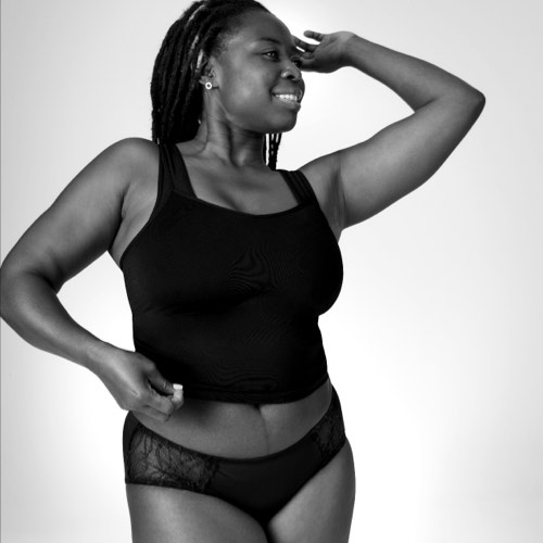 Woman wearing TENA Silhouette Washable Absorbent Underwear and a singlet, smiling. 